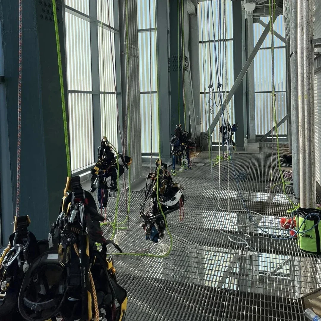 Rope access technicians training indoors on suspended ropes